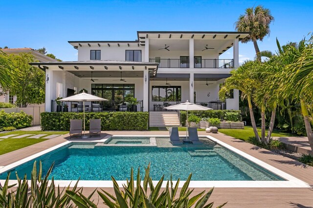 5004 S The Riviera, Tampa, FL 33609 - rear view of property featuring ceiling fan, stucco siding, a balcony, a pool with connected hot tub, and a patio area