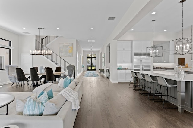 5004 S The Riviera, Tampa, FL 33609 - living room with a chandelier, dark wood-style flooring, recessed lighting, stairs, and baseboards