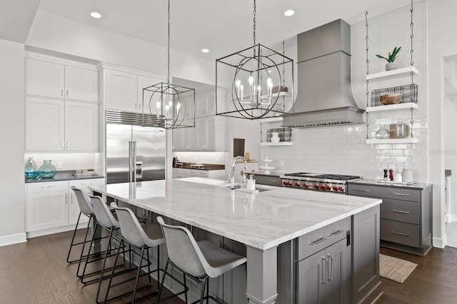 5004 S The Riviera, Tampa, FL 33609 - kitchen with premium range hood, built in fridge, a chandelier, open shelves, and gray cabinetry