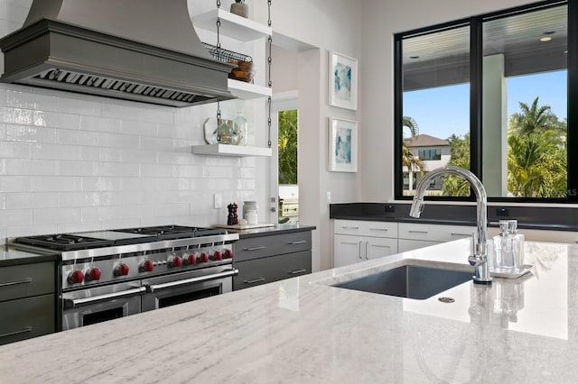 5004 S The Riviera, Tampa, FL 33609 - kitchen with range with two ovens, premium range hood, a sink, open shelves, and light stone counters
