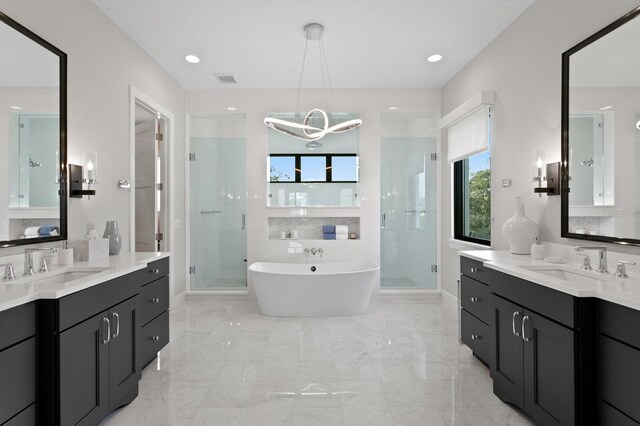5004 S The Riviera, Tampa, FL 33609 - bathroom with plenty of natural light, a shower stall, and two vanities