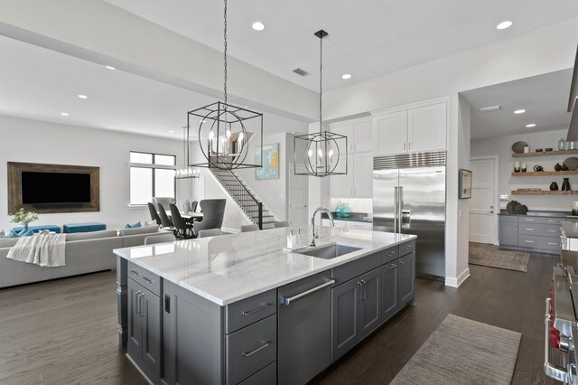 5004 S The Riviera, Tampa, FL 33609 - kitchen with a sink, stainless steel appliances, a chandelier, white cabinets, and gray cabinets