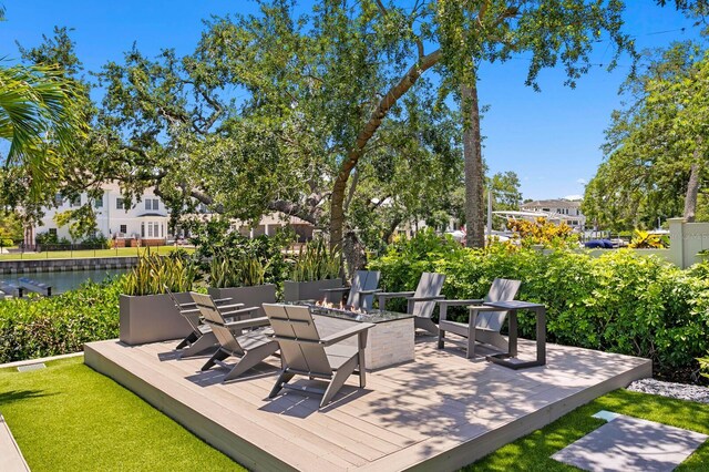 5004 S The Riviera, Tampa, FL 33609 - wooden terrace featuring an outdoor fire pit and a water view