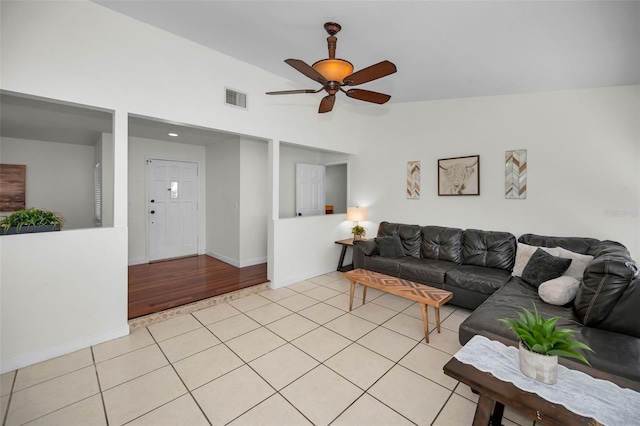 tiled living room featuring vaulted ceiling and ceiling fan