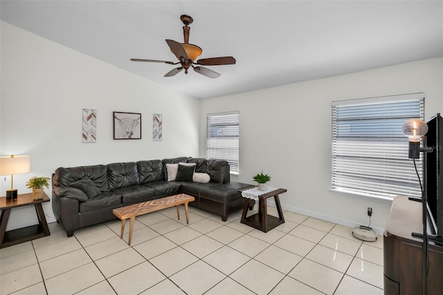 living room with ceiling fan, lofted ceiling, and light tile patterned floors