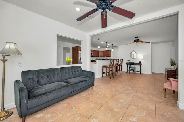 tiled living room with ceiling fan