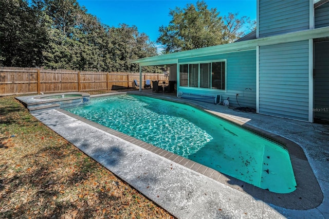 view of swimming pool featuring a patio area and an in ground hot tub