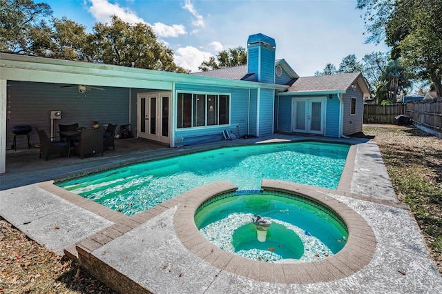 view of pool featuring french doors, an in ground hot tub, grilling area, ceiling fan, and a patio area