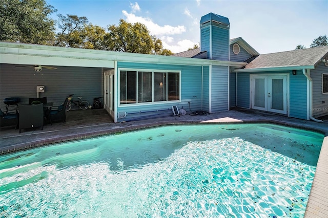 view of swimming pool with a patio area and french doors