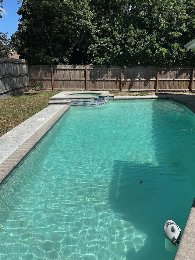 view of swimming pool featuring a fenced backyard, an in ground hot tub, and a fenced in pool