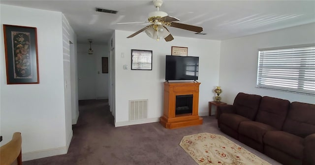 living area featuring a fireplace, carpet flooring, and visible vents