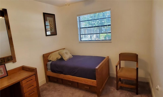 bedroom featuring light carpet and baseboards