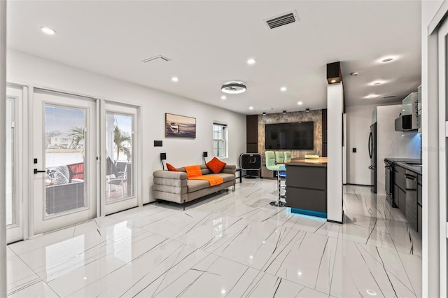 interior space featuring marble finish floor, visible vents, and recessed lighting