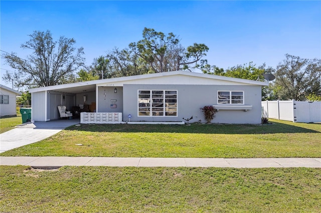 view of front of home with a front yard and a carport