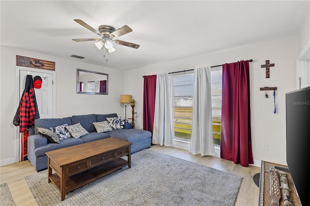 living room with ceiling fan and light hardwood / wood-style floors