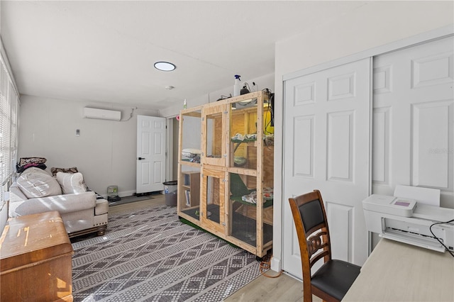 office featuring hardwood / wood-style flooring and a wall unit AC