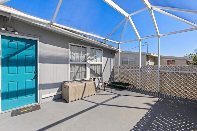 view of patio with glass enclosure