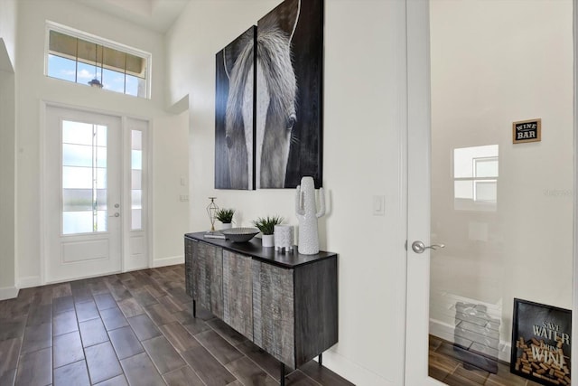 entryway featuring wood finish floors, baseboards, and plenty of natural light