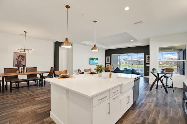 kitchen with open floor plan, dishwasher, dark wood-style flooring, recessed lighting, and a sink