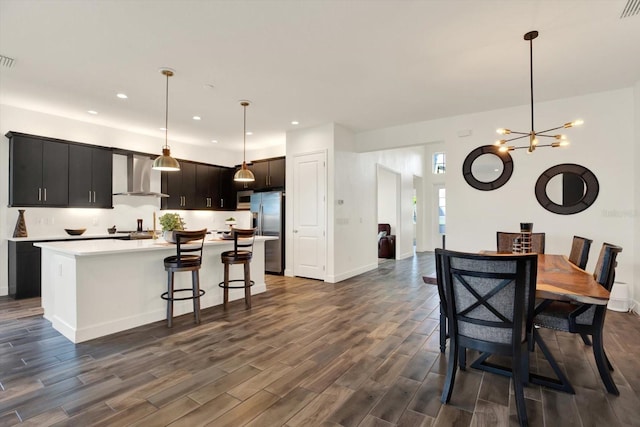 dining area featuring recessed lighting, baseboards, an inviting chandelier, and dark wood finished floors