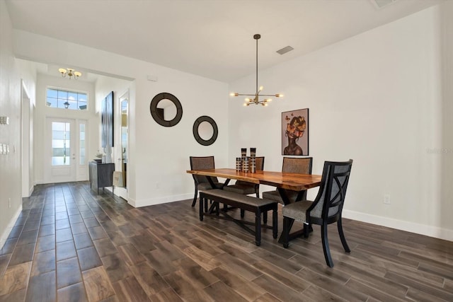 dining space featuring visible vents, baseboards, a notable chandelier, and dark wood finished floors