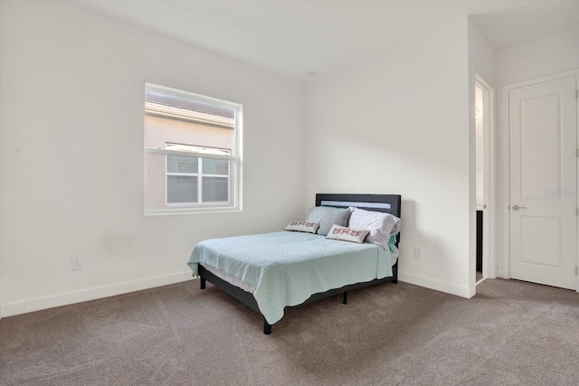 carpeted bedroom featuring baseboards