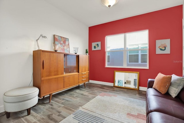 living area featuring baseboards and wood finished floors