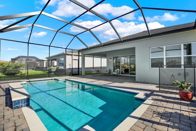 outdoor pool with a lanai and a patio