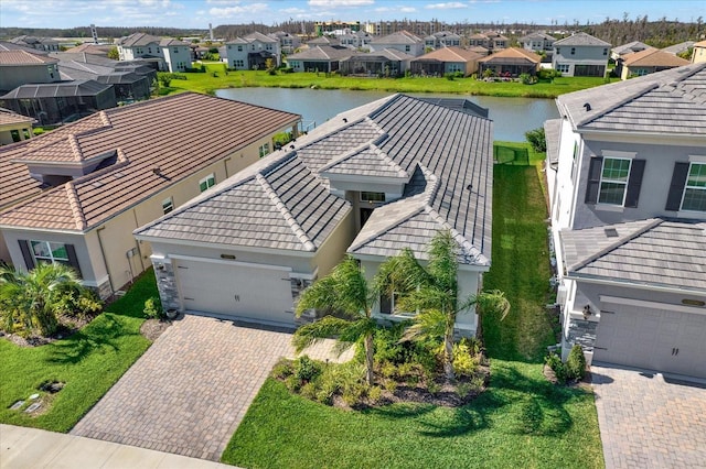 drone / aerial view featuring a residential view and a water view