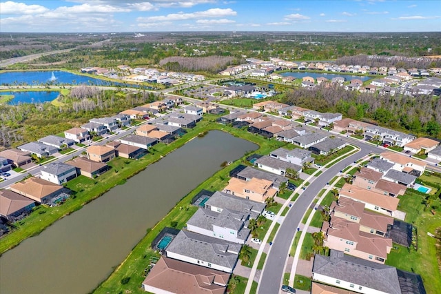 drone / aerial view featuring a water view and a residential view