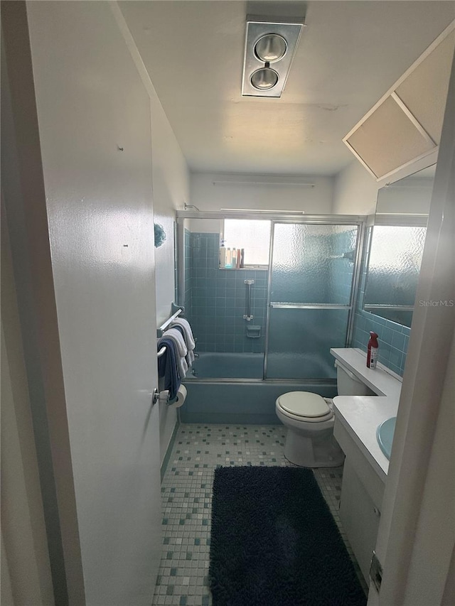 14132 89th Ave, Seminole, FL 33776 - full bath featuring toilet, bath / shower combo with glass door, and vanity