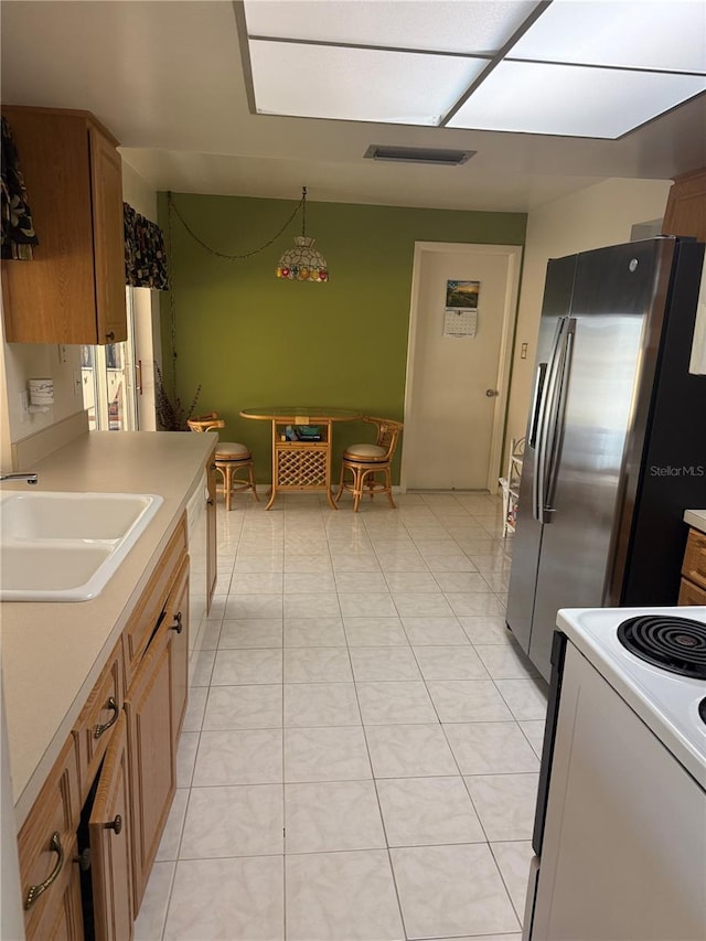 14132 89th Ave, Seminole, FL 33776 - kitchen with brown cabinetry, white appliances, light countertops, and a sink