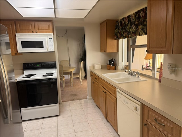 14132 89th Ave, Seminole, FL 33776 - kitchen featuring light countertops, white appliances, a sink, and brown cabinets
