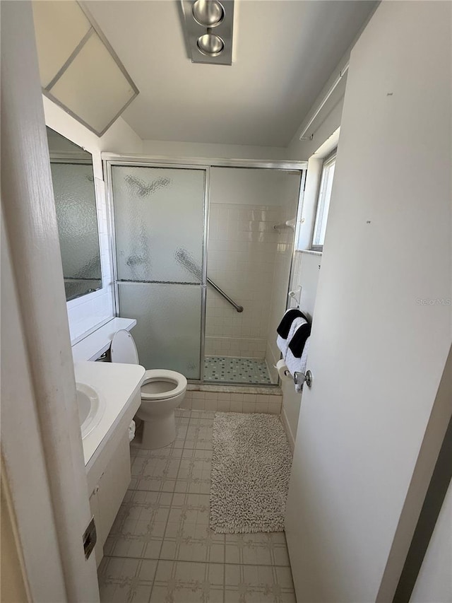 14132 89th Ave, Seminole, FL 33776 - full bathroom featuring a stall shower, vanity, and toilet