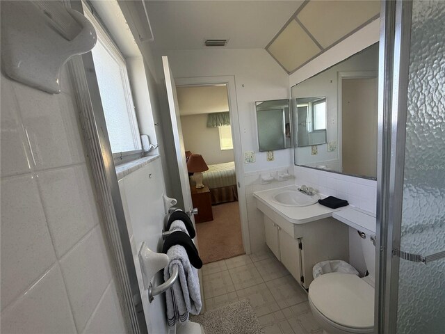 14132 89th Ave, Seminole, FL 33776 - bathroom with ensuite bathroom, toilet, a wainscoted wall, vanity, and visible vents