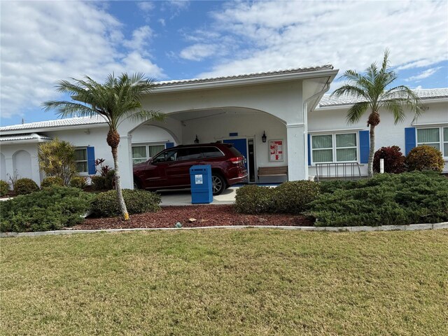 14132 89th Ave, Seminole, FL 33776 - view of front of home with a front lawn, an attached carport, and stucco siding