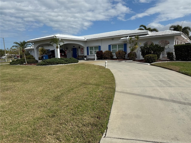 14132 89th Ave, Seminole, FL 33776 - ranch-style house featuring driveway, stucco siding, a tile roof, and a front yard