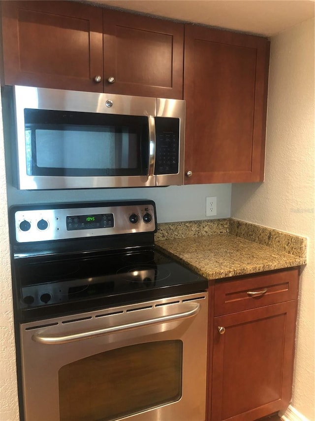 kitchen with light stone counters and stainless steel appliances