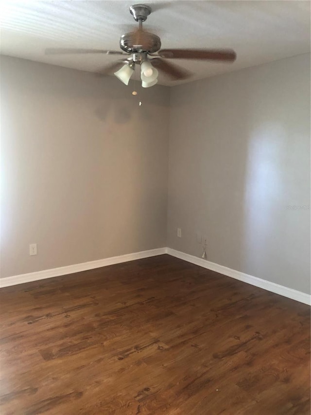 spare room featuring dark hardwood / wood-style floors and ceiling fan