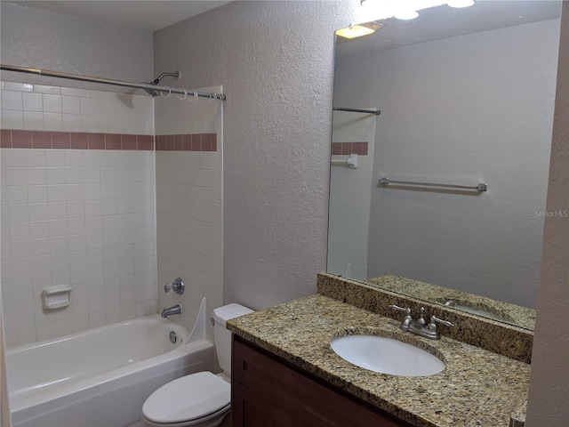 full bathroom featuring tiled shower / bath combo, vanity, and toilet