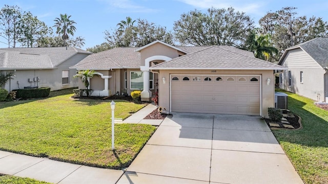 single story home featuring concrete driveway, stucco siding, an attached garage, central air condition unit, and a front yard