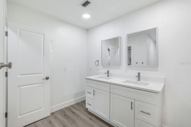 bathroom with hardwood / wood-style flooring and vanity