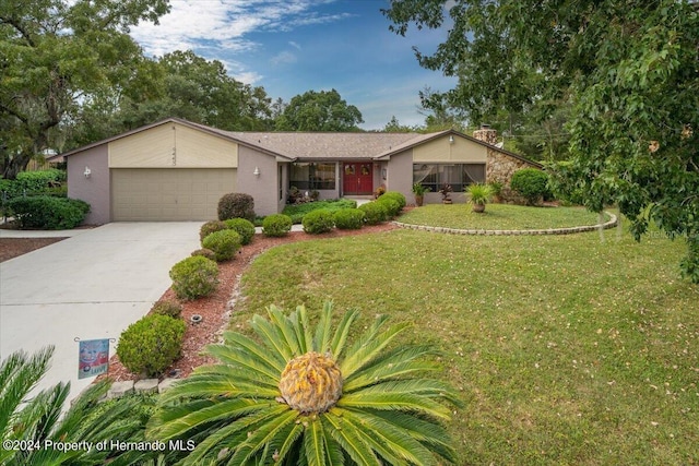 ranch-style house with a garage and a front yard