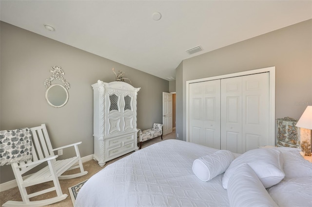 bedroom with carpet, lofted ceiling, and a closet