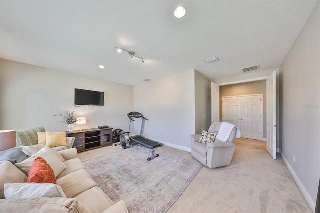 exercise room featuring light colored carpet