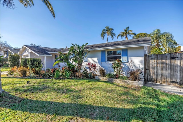 single story home with a front yard, fence, and stucco siding