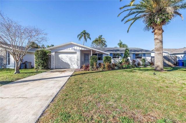 view of front of home with a front lawn, driveway, an attached garage, and fence