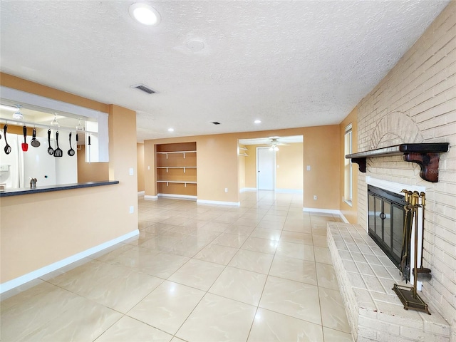 unfurnished living room featuring a fireplace, a textured ceiling, baseboards, and ceiling fan