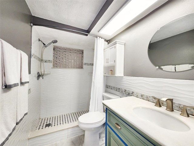 bathroom with a stall shower, toilet, marble finish floor, a textured ceiling, and vanity