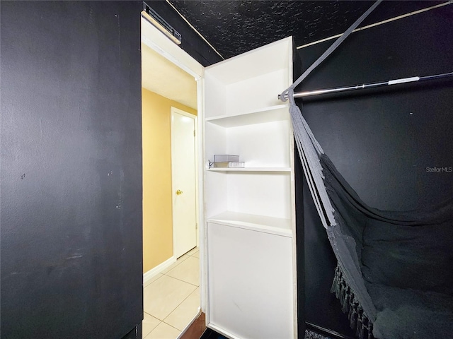 walk in closet with tile patterned floors